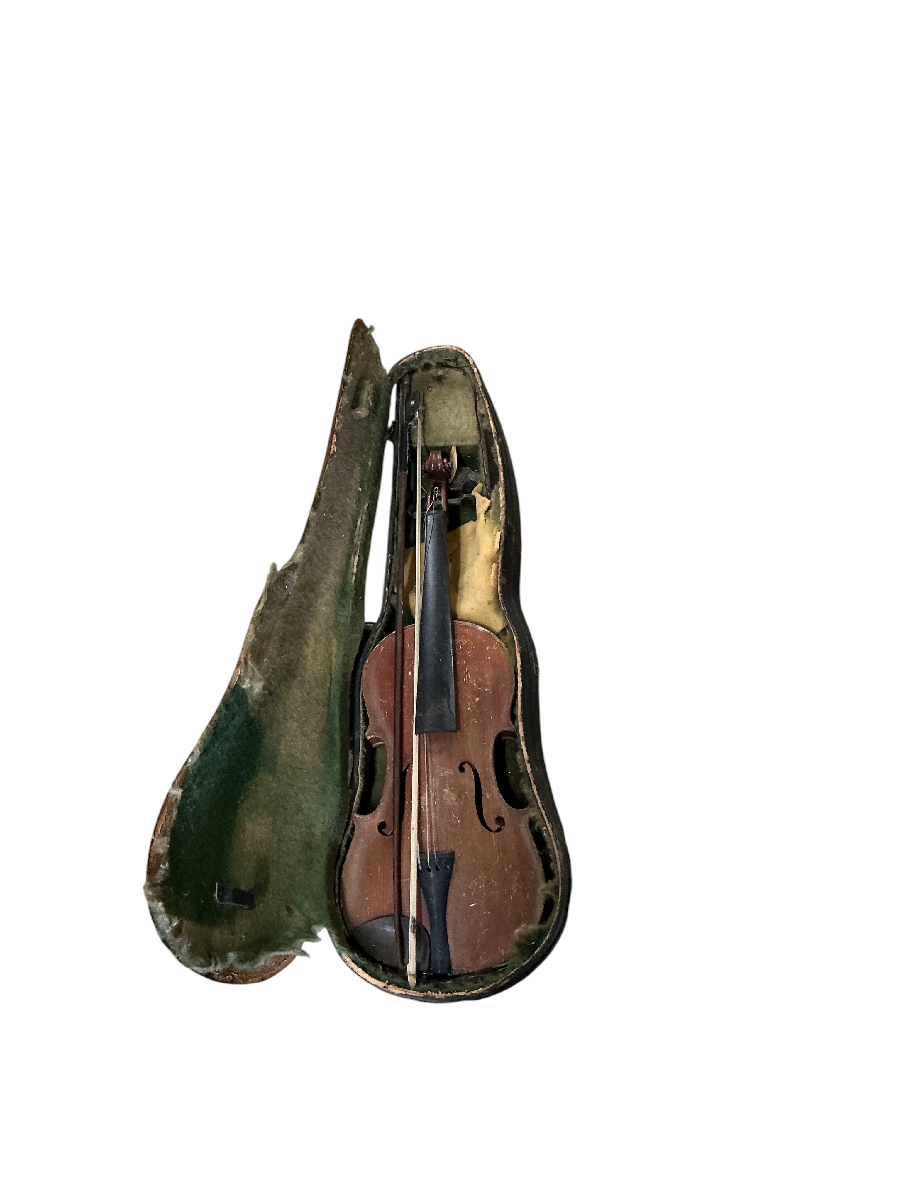 A small cello and assorted instruments in need of restoration